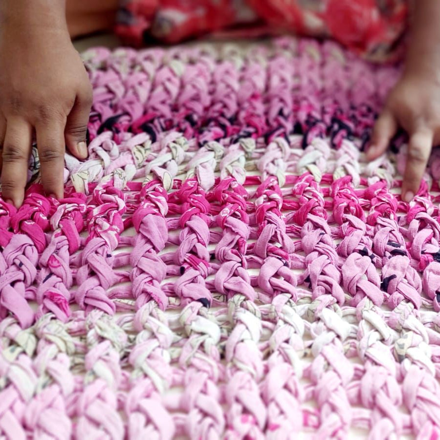 artisan working on pink chunky knit cushion cover