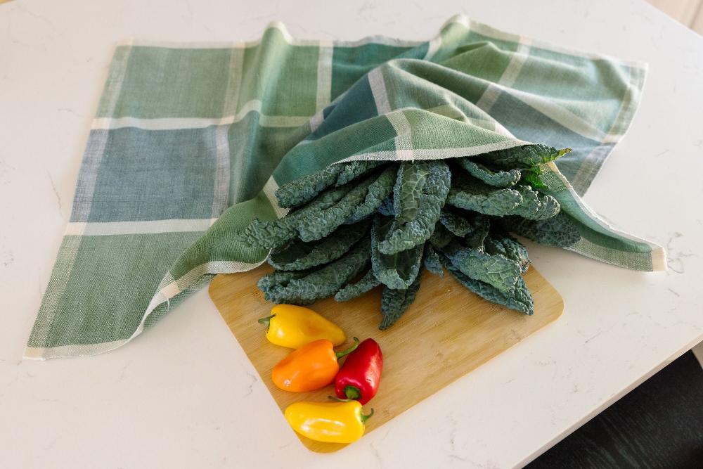 Jane kitchen towel in flax with cutting board and vegetables