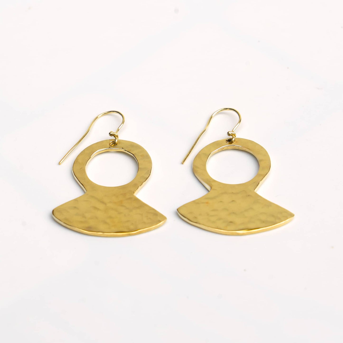 Juba hammered brass teardrop pendant earrings flat lay — Ecodunia