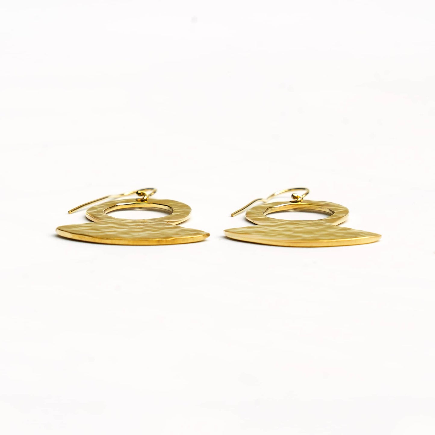 Juba hammered brass pendant earrings worn showing texture