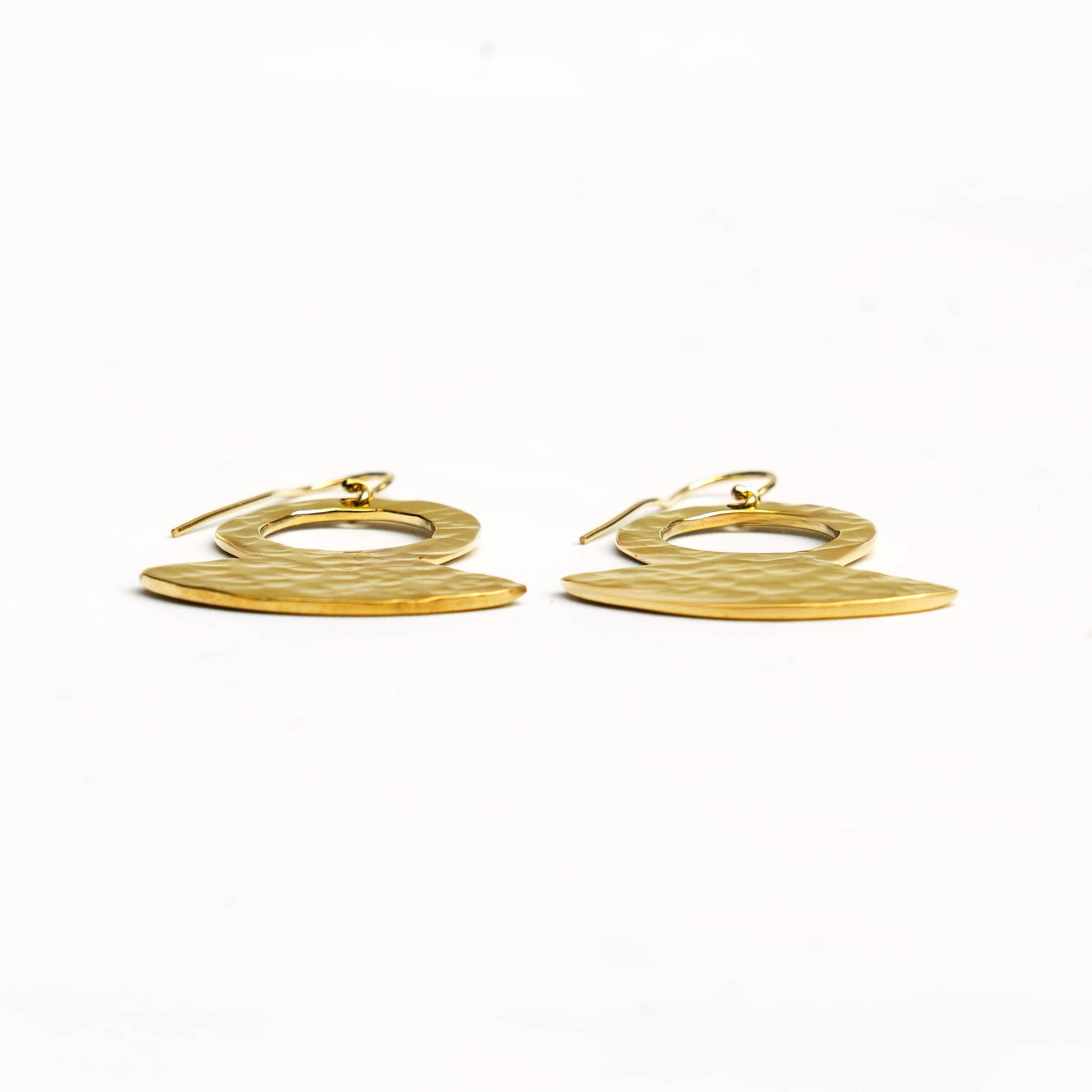 Juba hammered brass pendant earrings worn showing texture
