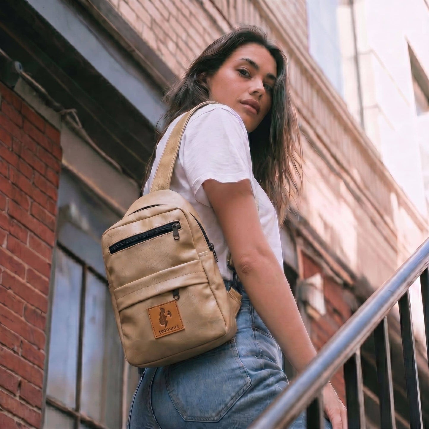 Umoja latte vegan leather sling bag flat lay #color_latte