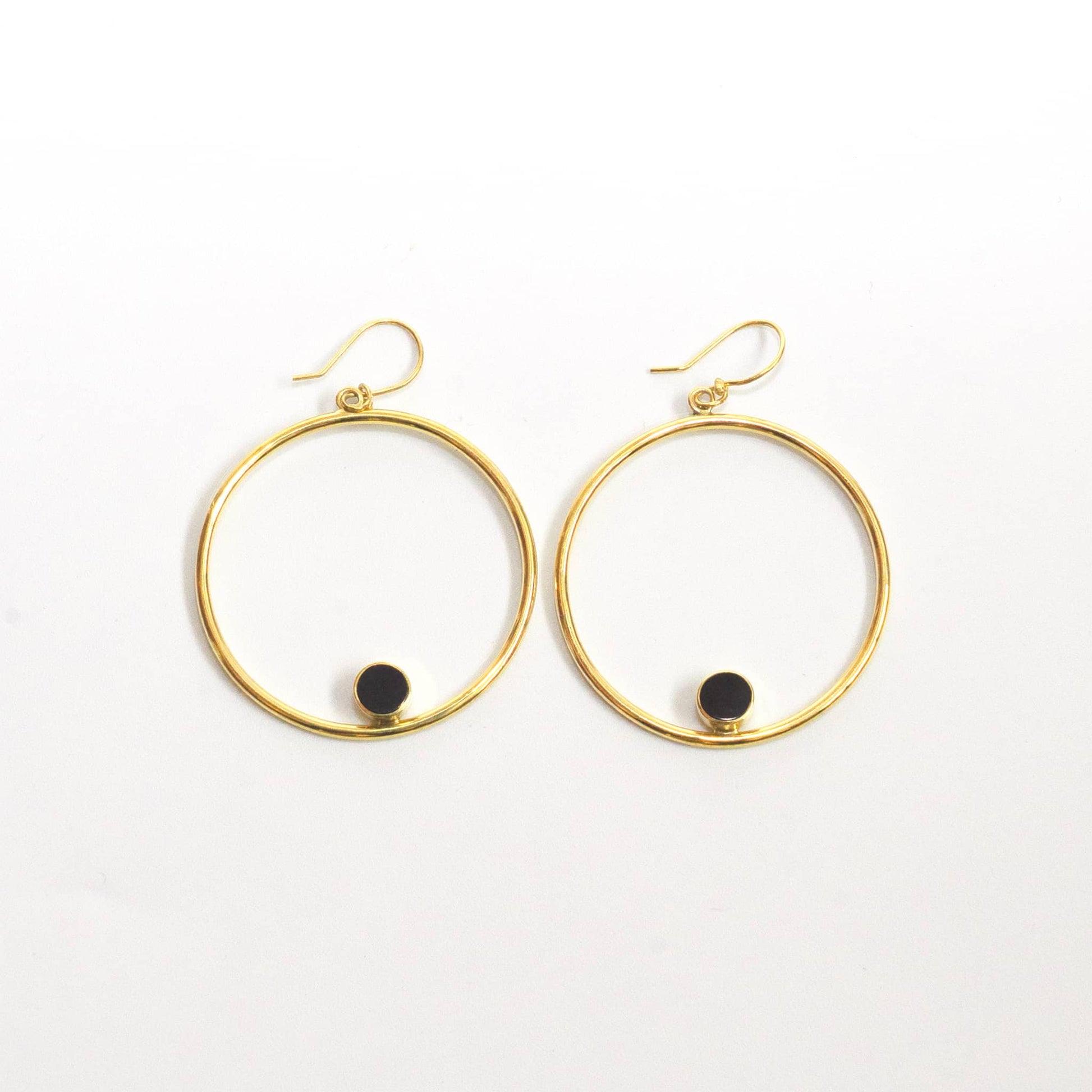 Lozi brass hoop with black horn accent earrings flat lay — Ecodunia
