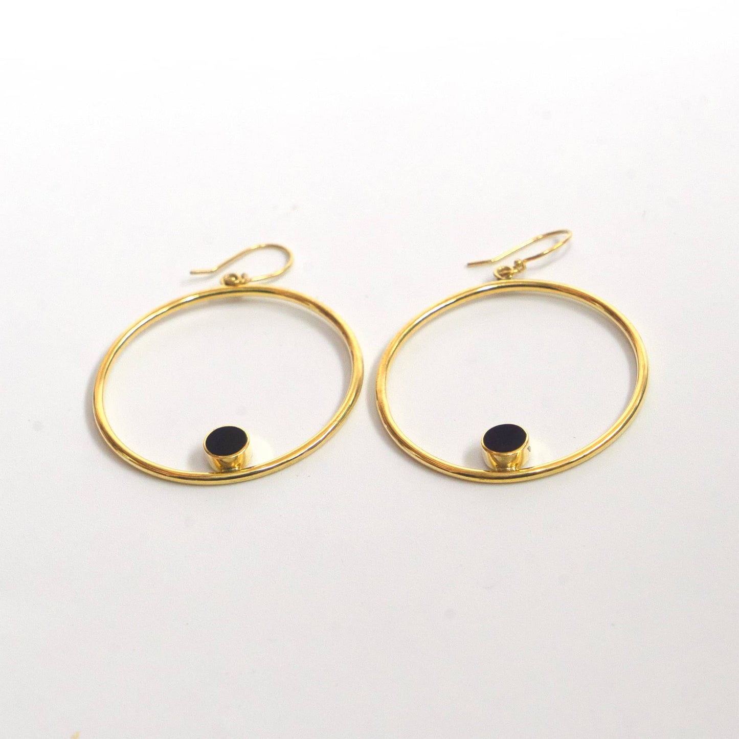 Lozi brass and horn hoop earrings worn showing accent detail