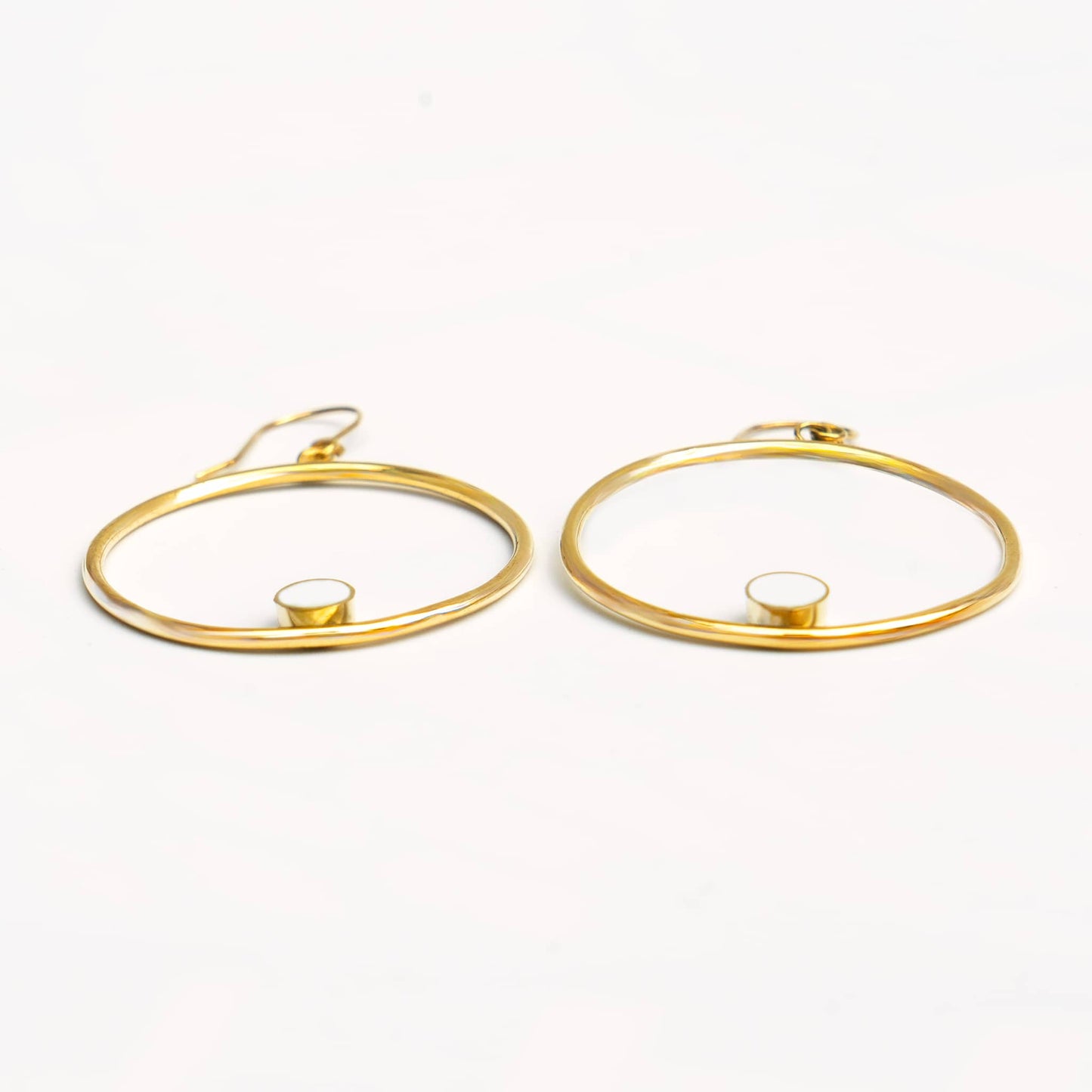 Lozi brass hoop with white horn accent earrings flat lay — Ecodunia