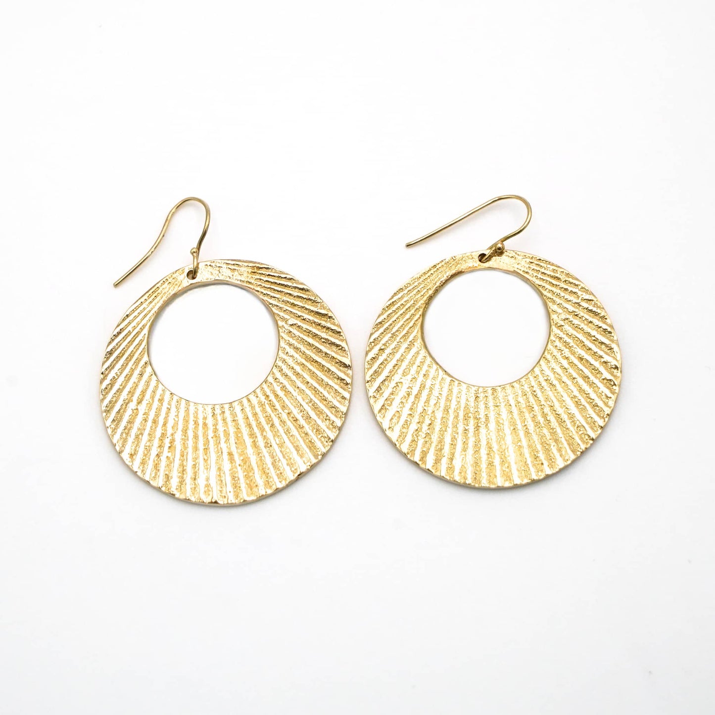 Mali brass disc hoop earrings worn showing sunburst pattern