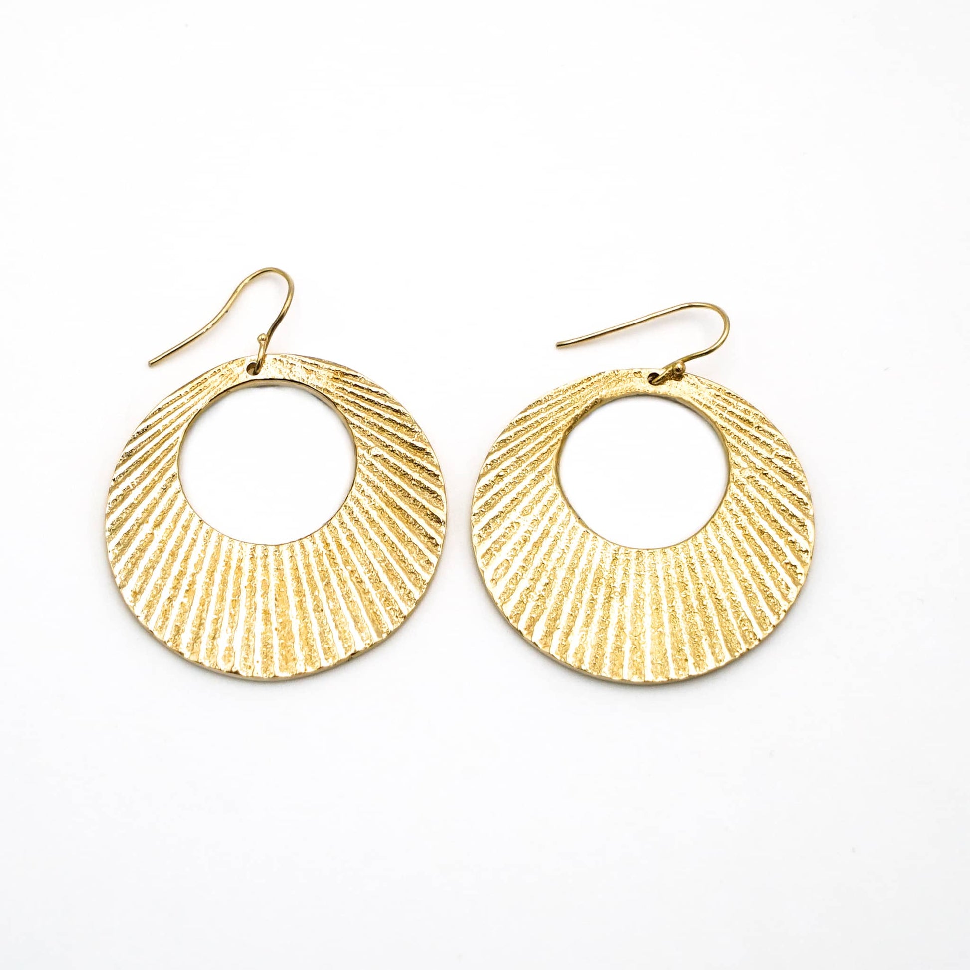 Mali engraved circle disc brass hoop earrings flat lay — Ecodunia