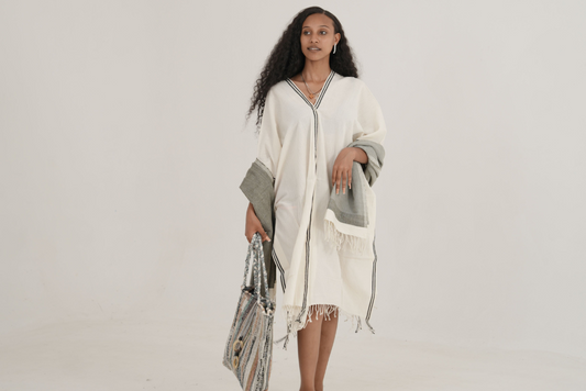 Model wearing petra kaftan holding fasika bag