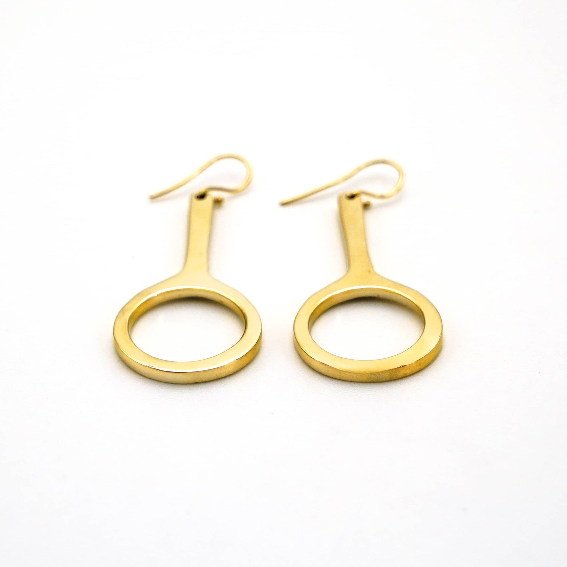 Mwenzi hoop drop brass earrings worn showing layered silhouette