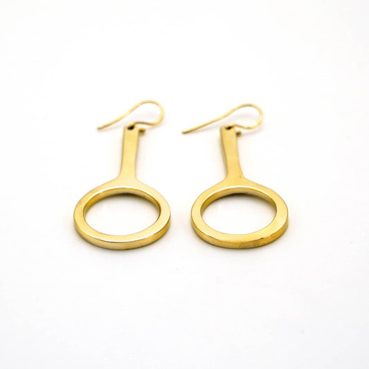Mwenzi hoop drop brass earrings worn showing layered silhouette