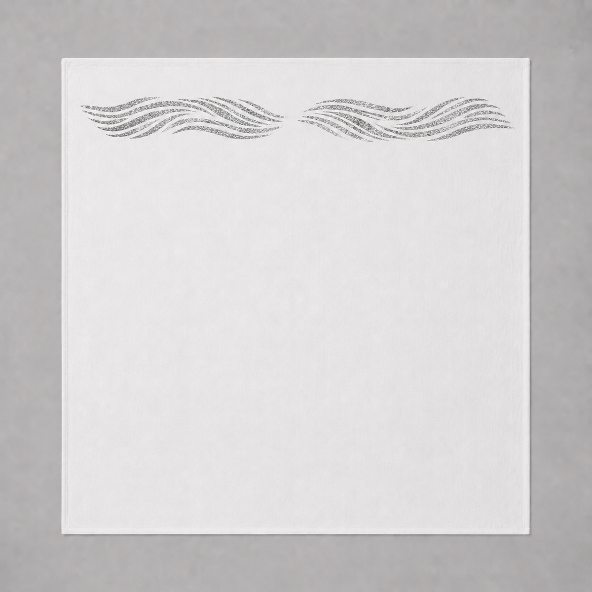 White swaddle blanket with silver sparkly reflective waves on a gray background