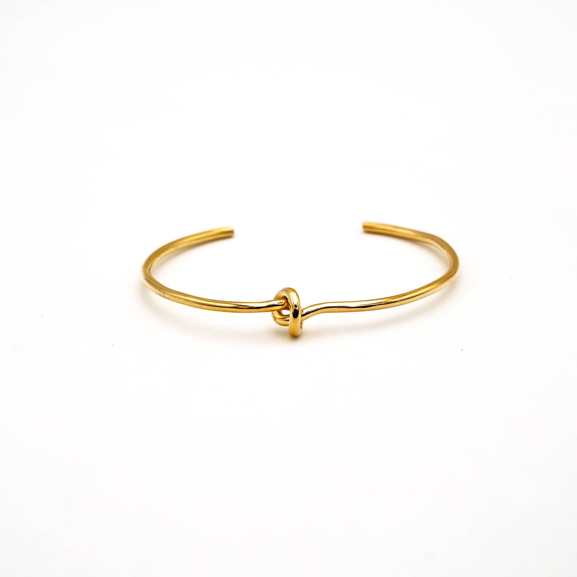 Tatu knot brass choker necklace worn on neck showing center knot detail
