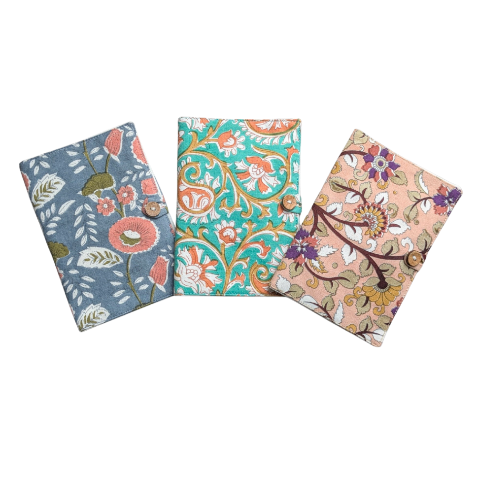 Three floral-patterned passport covers on a white background