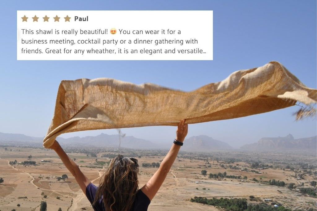 Person holding queen saba shawl with a scenic background and a product review overlay.