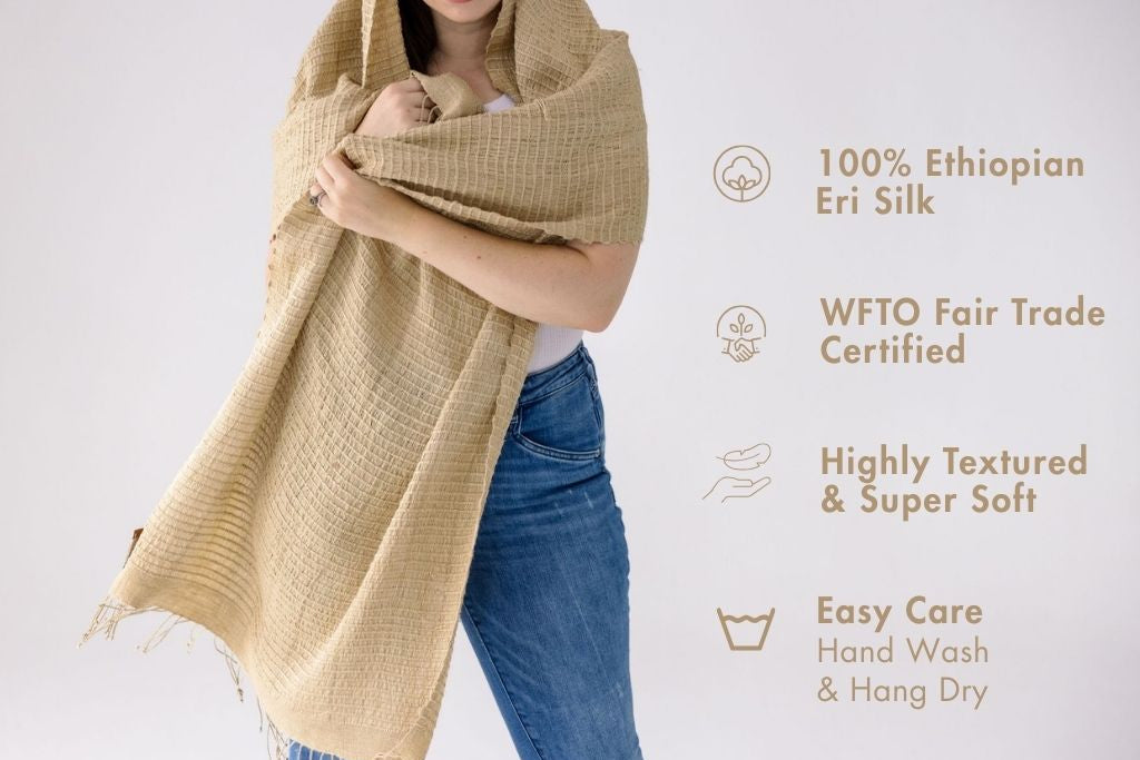 Person wearing a queen saba almond shawl with product details on a white background