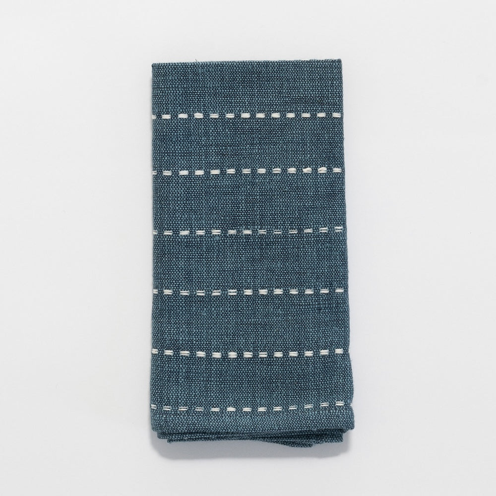 Rift Valley cocktail napkin in flax folded on white background