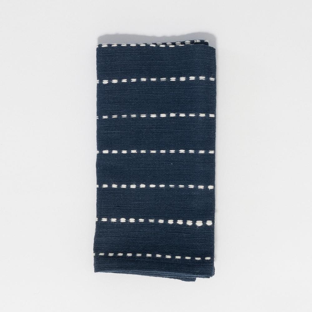 Rift valley cocktail napkin in navy flat lay