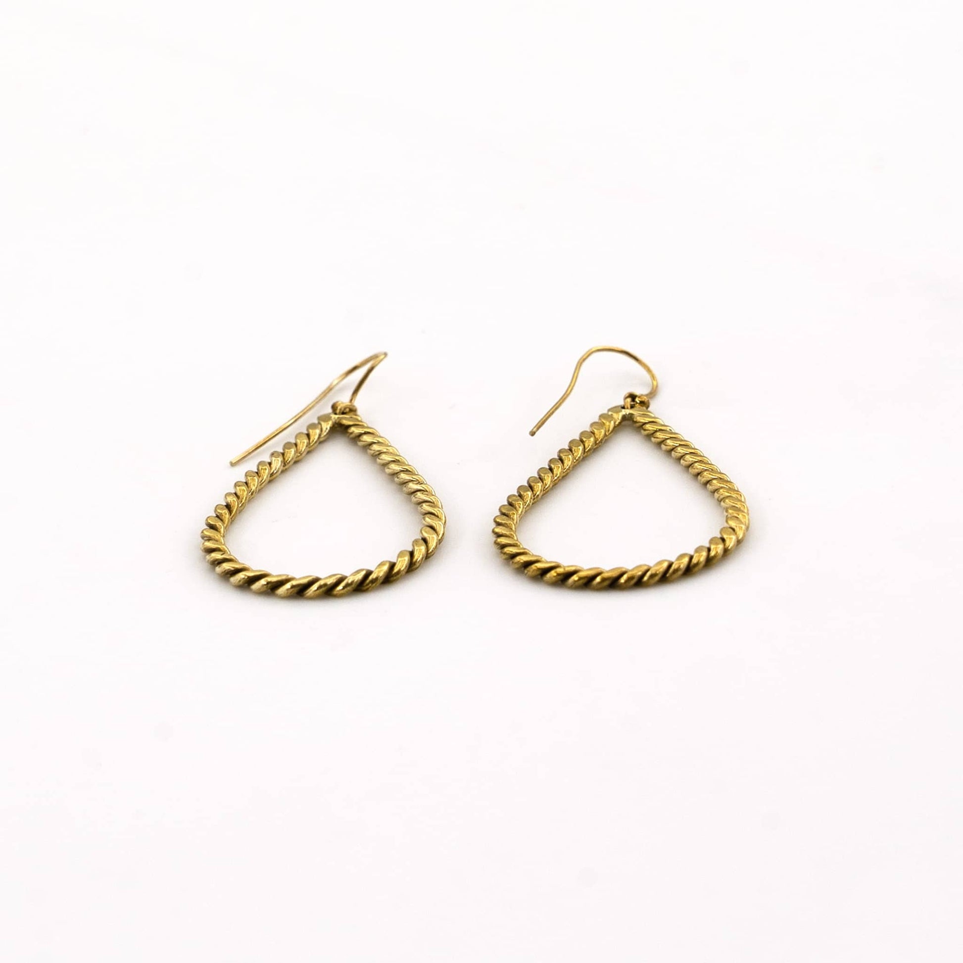 Rosa twisted brass hoop earrings flat lay — Ecodunia