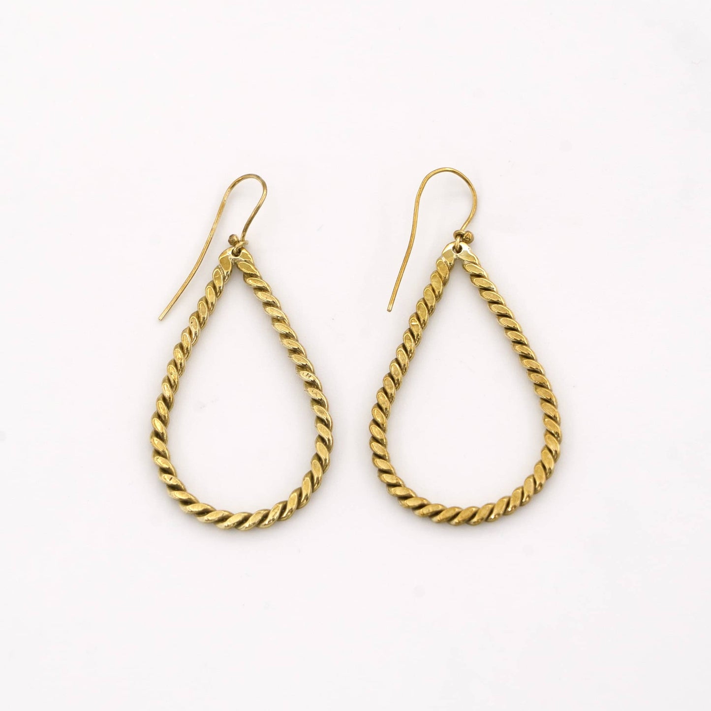 Rosa twisted brass hoop earrings worn showing rope texture