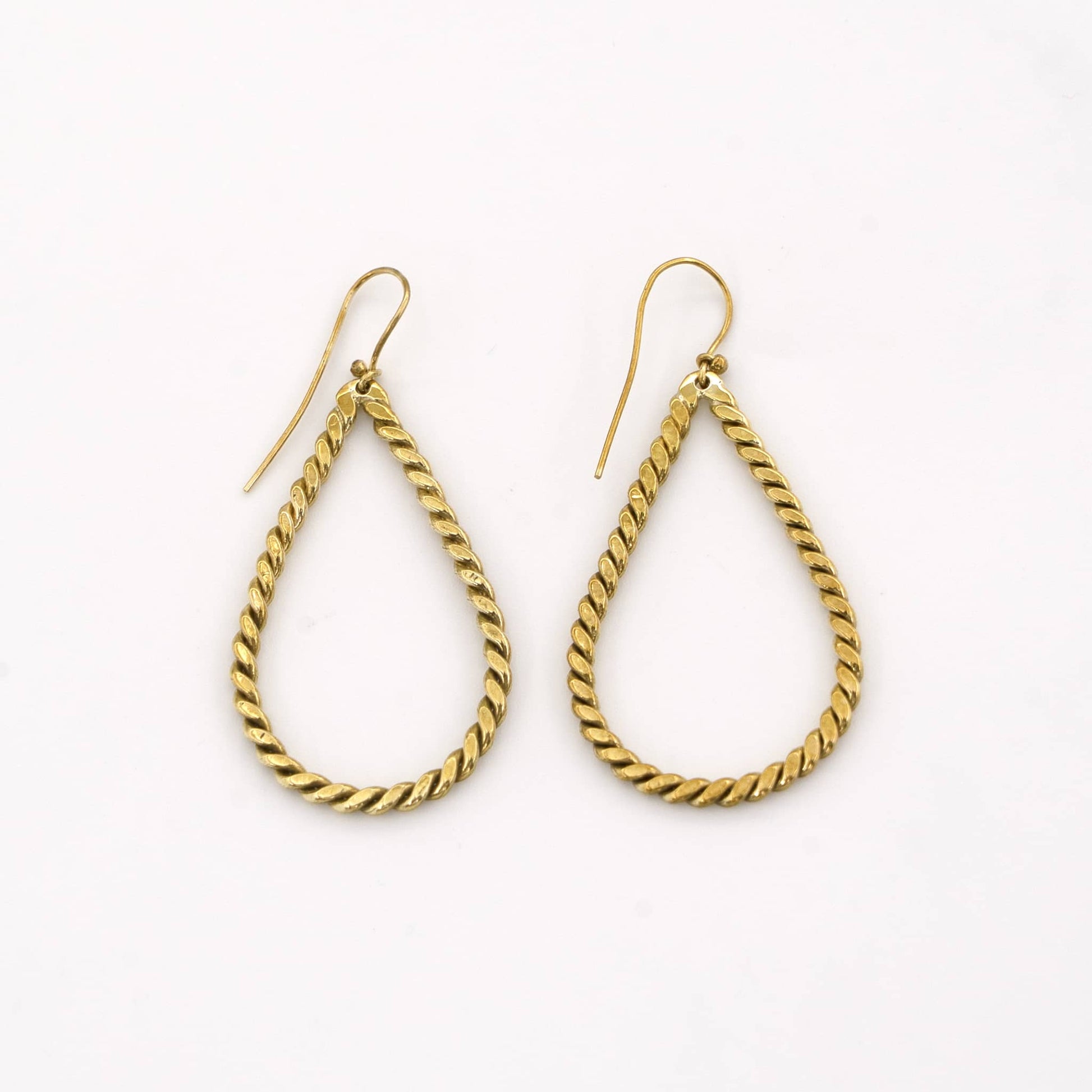 Rosa twisted brass hoop earrings worn showing rope texture