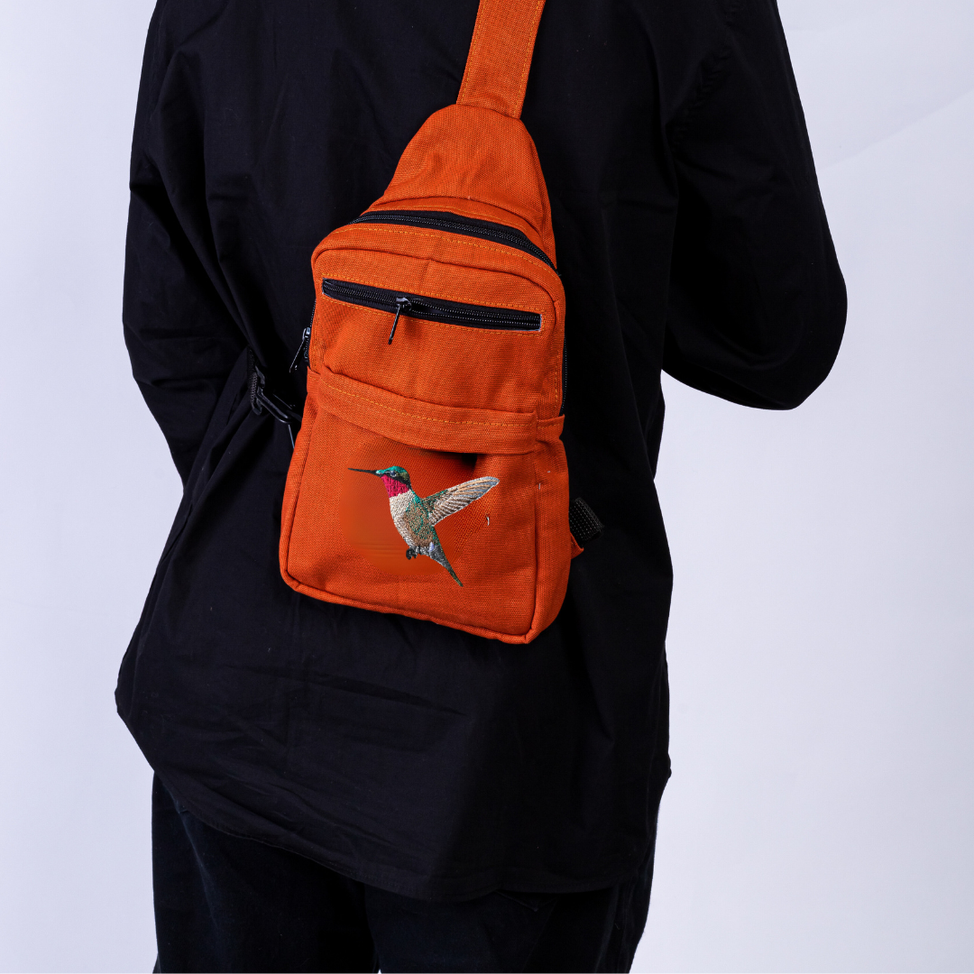 Umoja hummingbird embroidered canvas sling bag in rust #color_rust