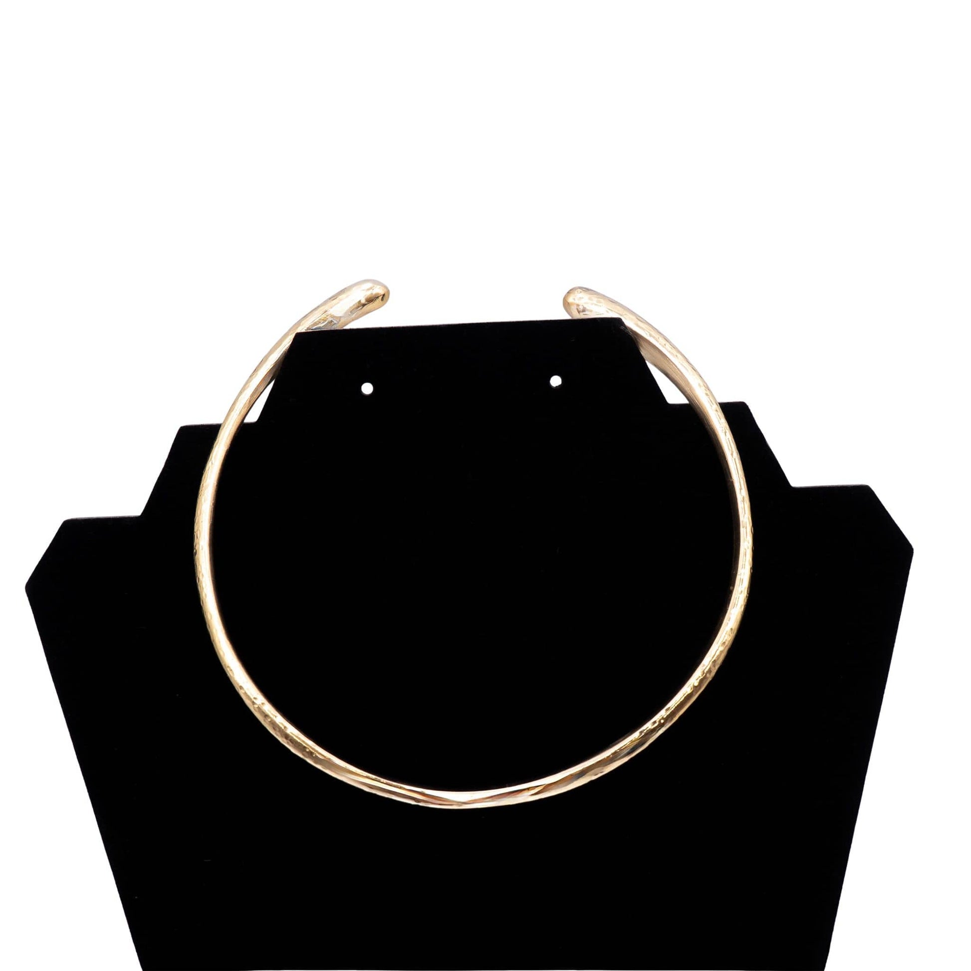 Sana hammered brass cuff choker necklace flat lay on warm surface — Ecodunia