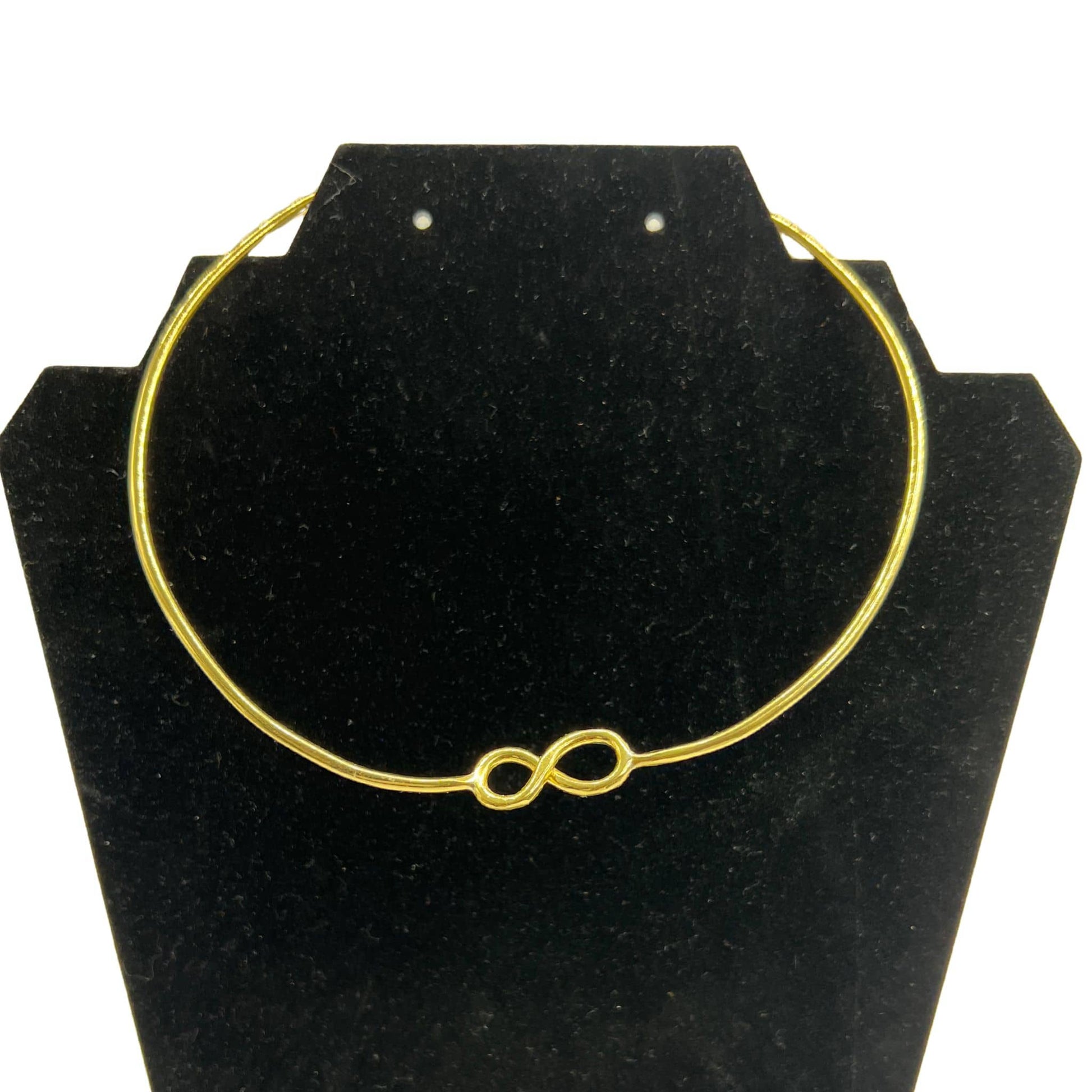 Saya infinite cuff brass choker necklace flat lay on warm surface — Ecodunia