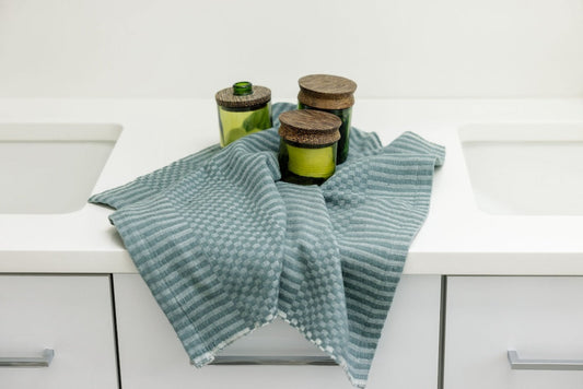 Tana hand towel in flax on bathroom counter