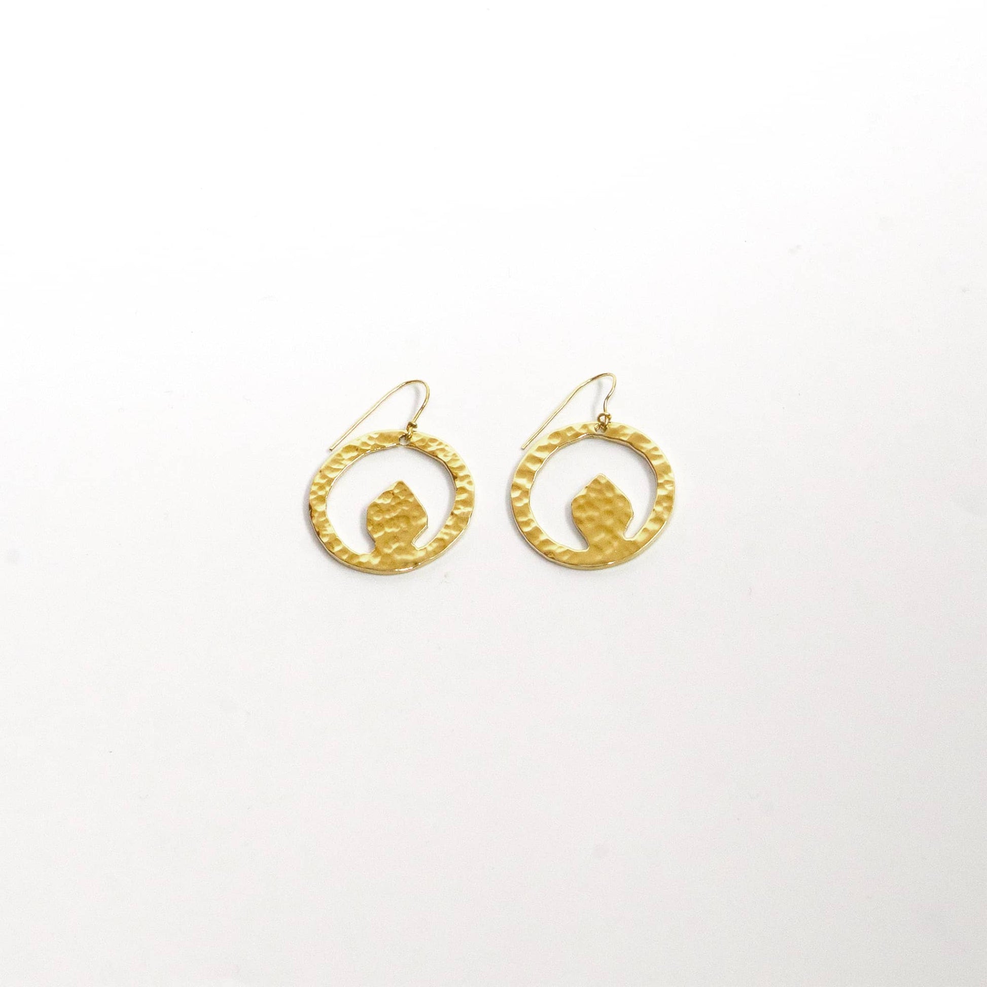 Tembo hammered brass disc earrings worn showing organic shape