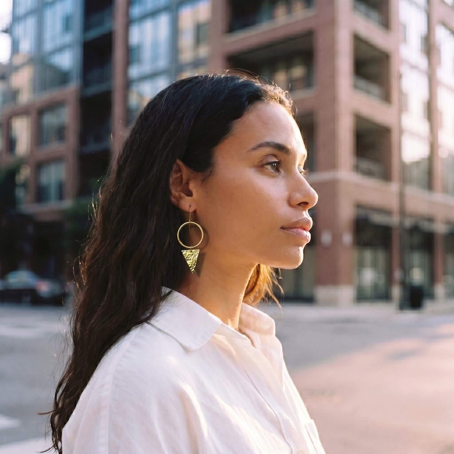 Wema circle hoop with triangle drop brass earrings worn — Ecodunia