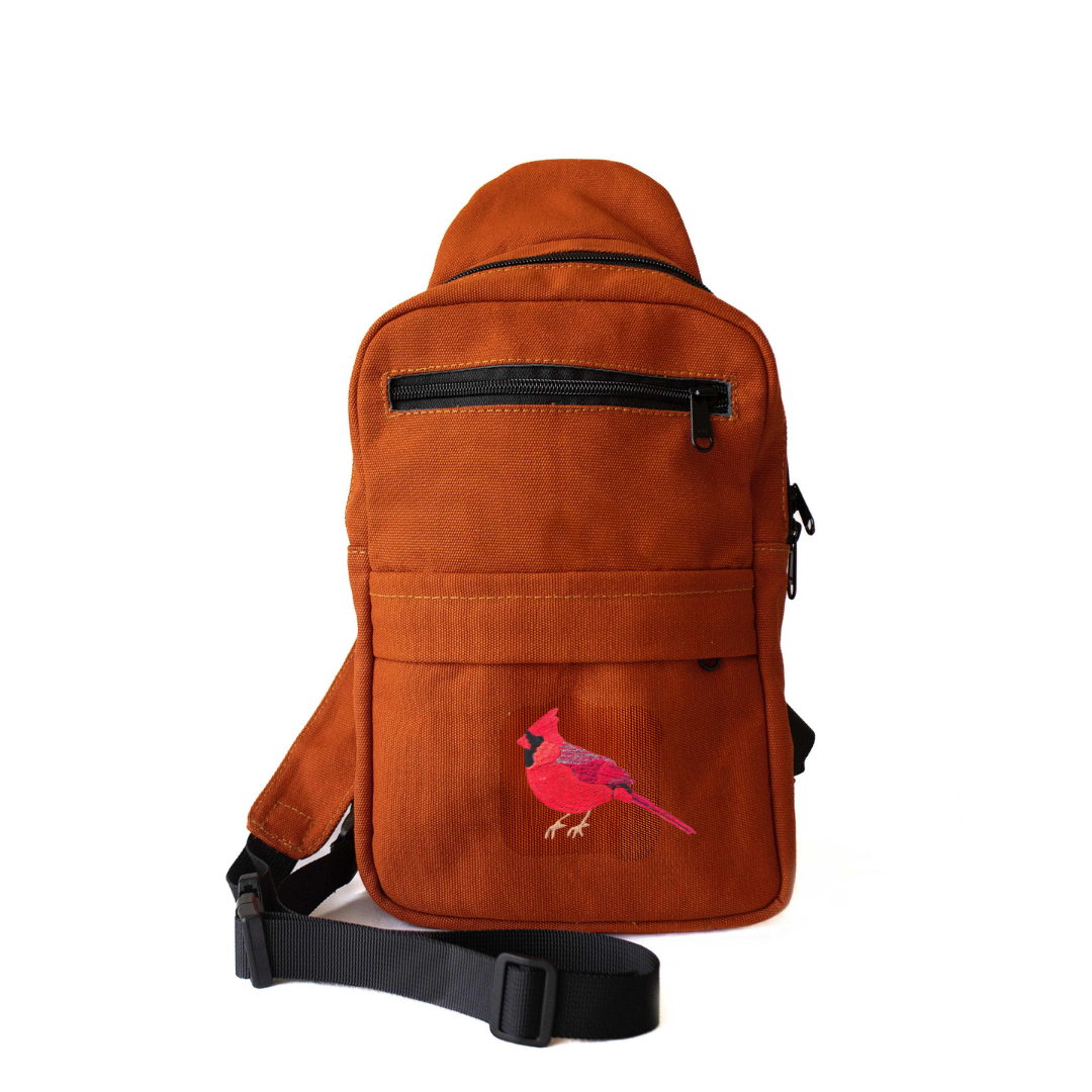 Cardinal Umoja embroidered canvas unisex sling bag in rust #color_rust
