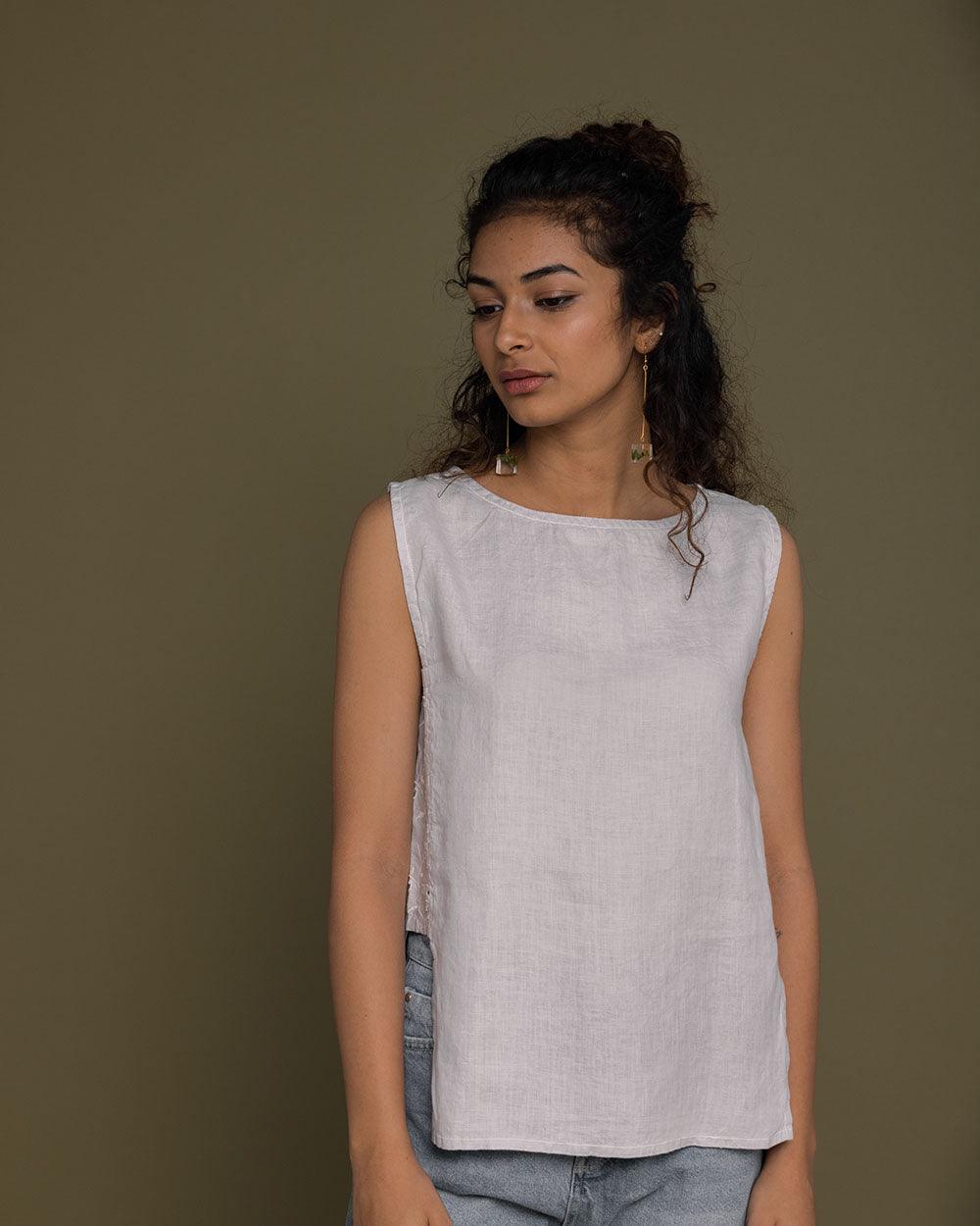 boxed grey sleeveless top with embroidered detailing on the sides, boat neck. reistor