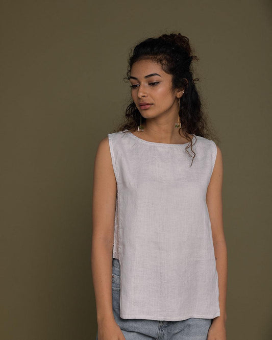 boxed grey sleeveless top with embroidered detailing on the sides, boat neck. reistor