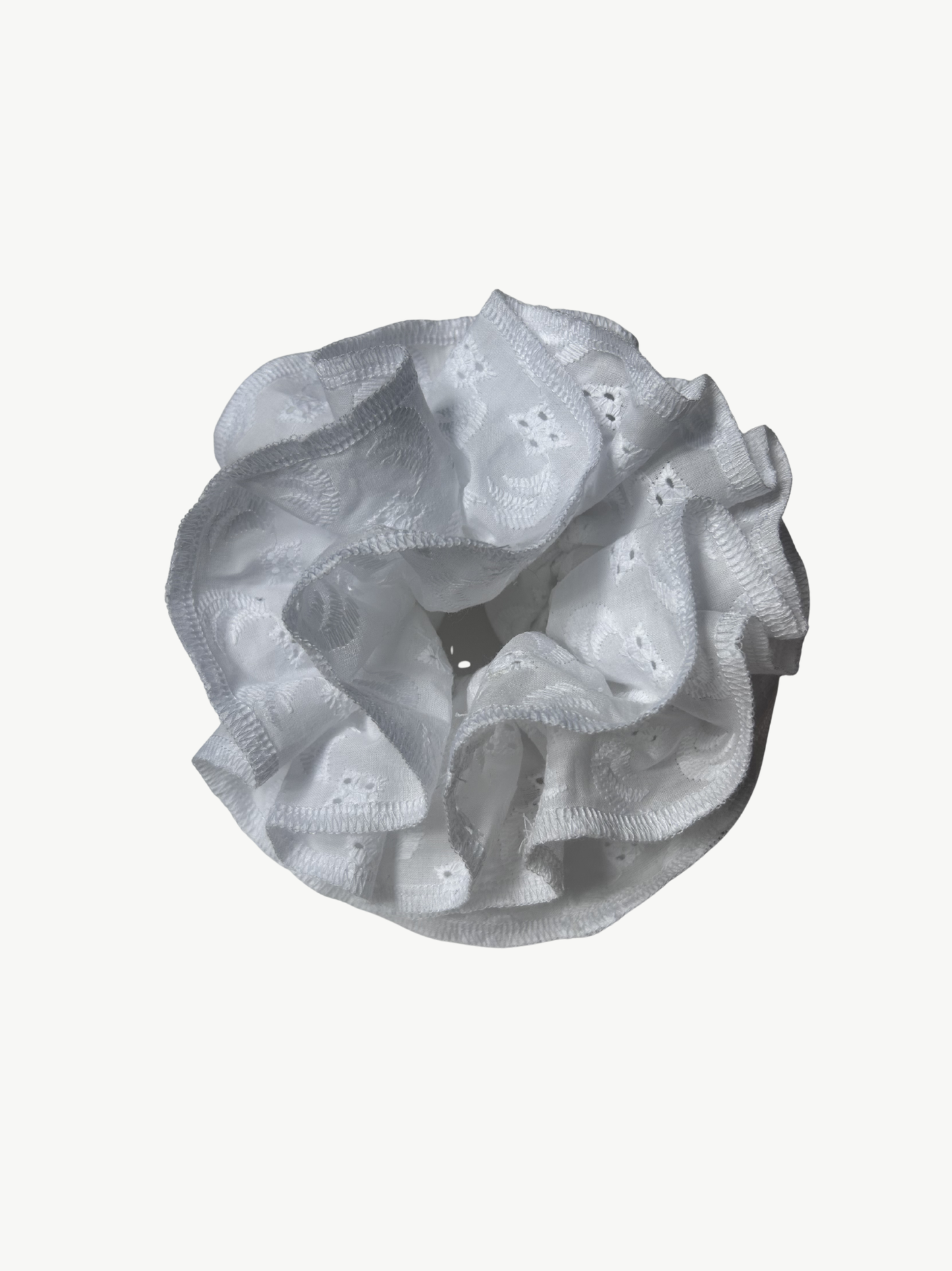 white Broderie Anglaise scrunchie on a white background