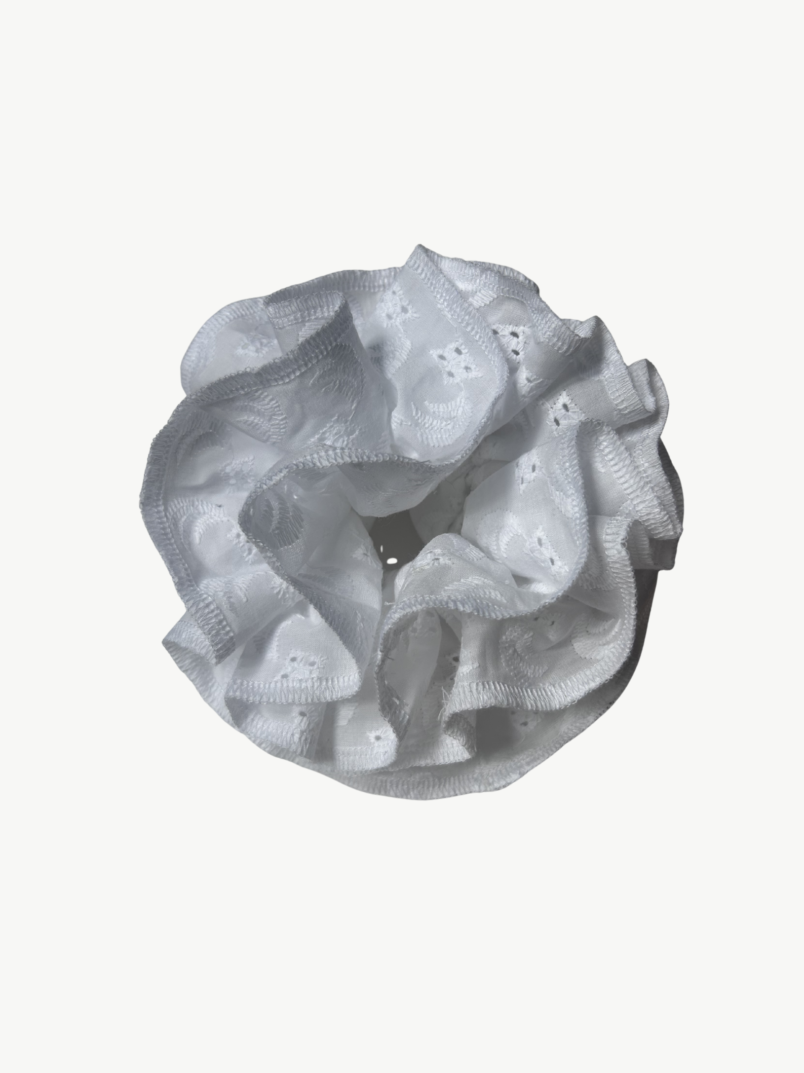 white Broderie Anglaise scrunchie on a white background