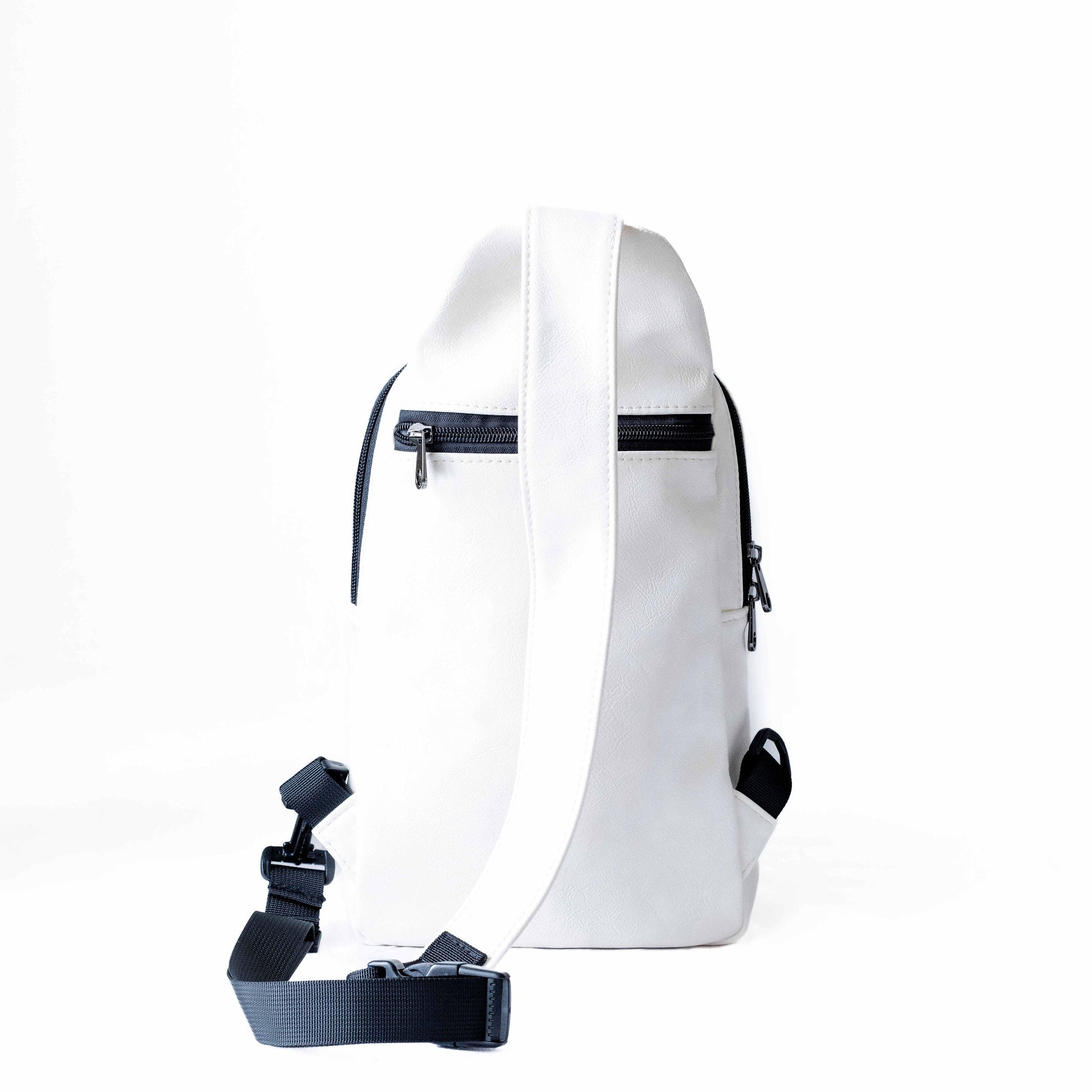 Umoja white vegan leather crossbody sling bag flat lay #color_white