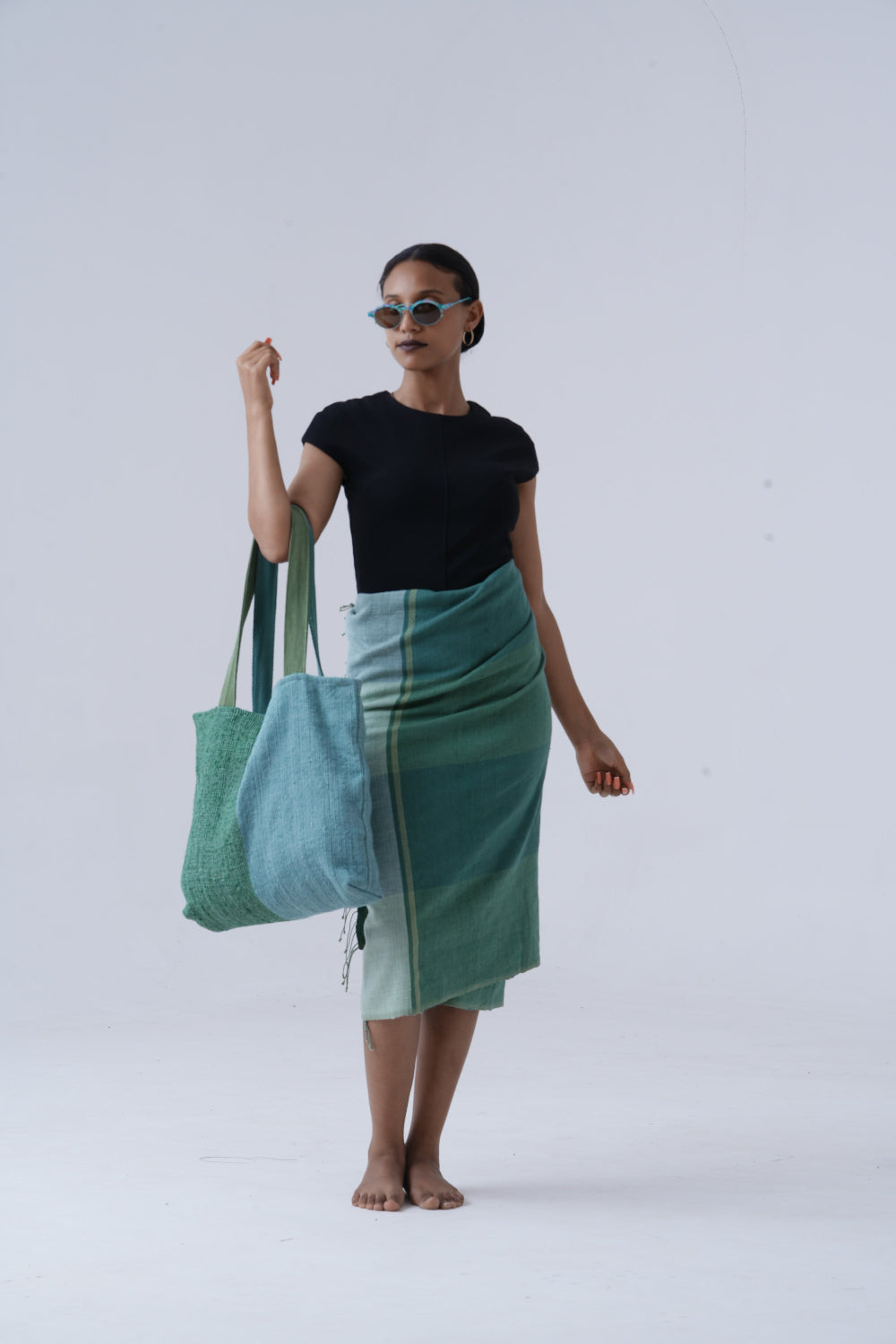 Woman holding borsa tote bag against a white background