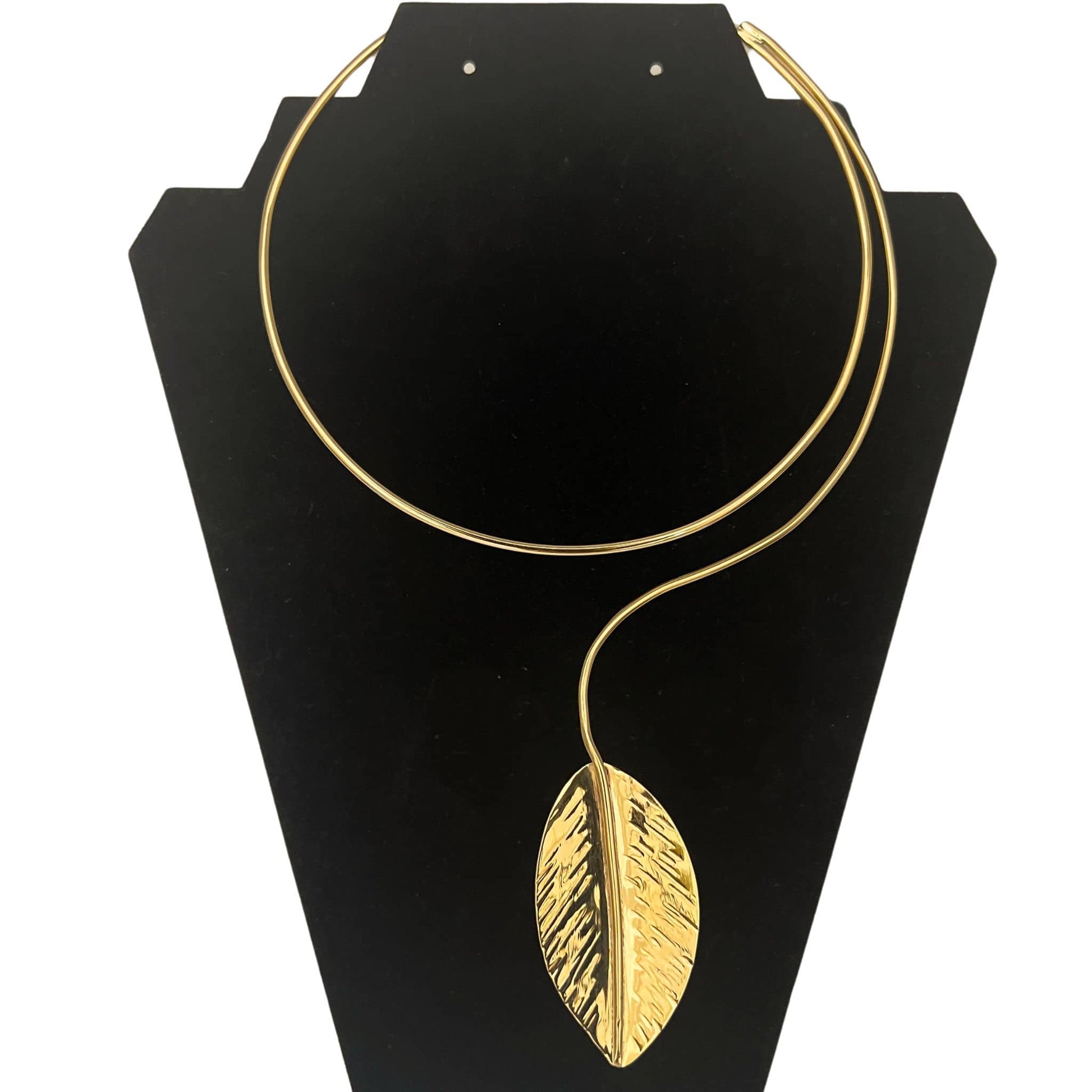 Zizi leaf pendant wrap brass choker necklace flat lay on warm surface — Ecodunia