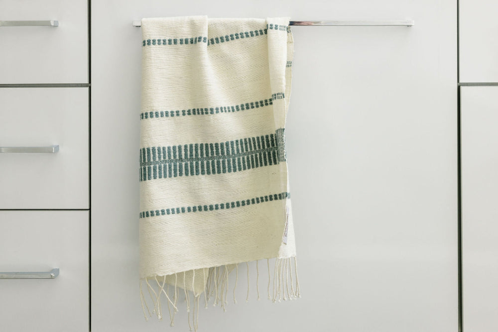 abaya hand towel in slate hanging in bathroom