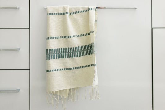 abaya hand towel in slate hanging in bathroom