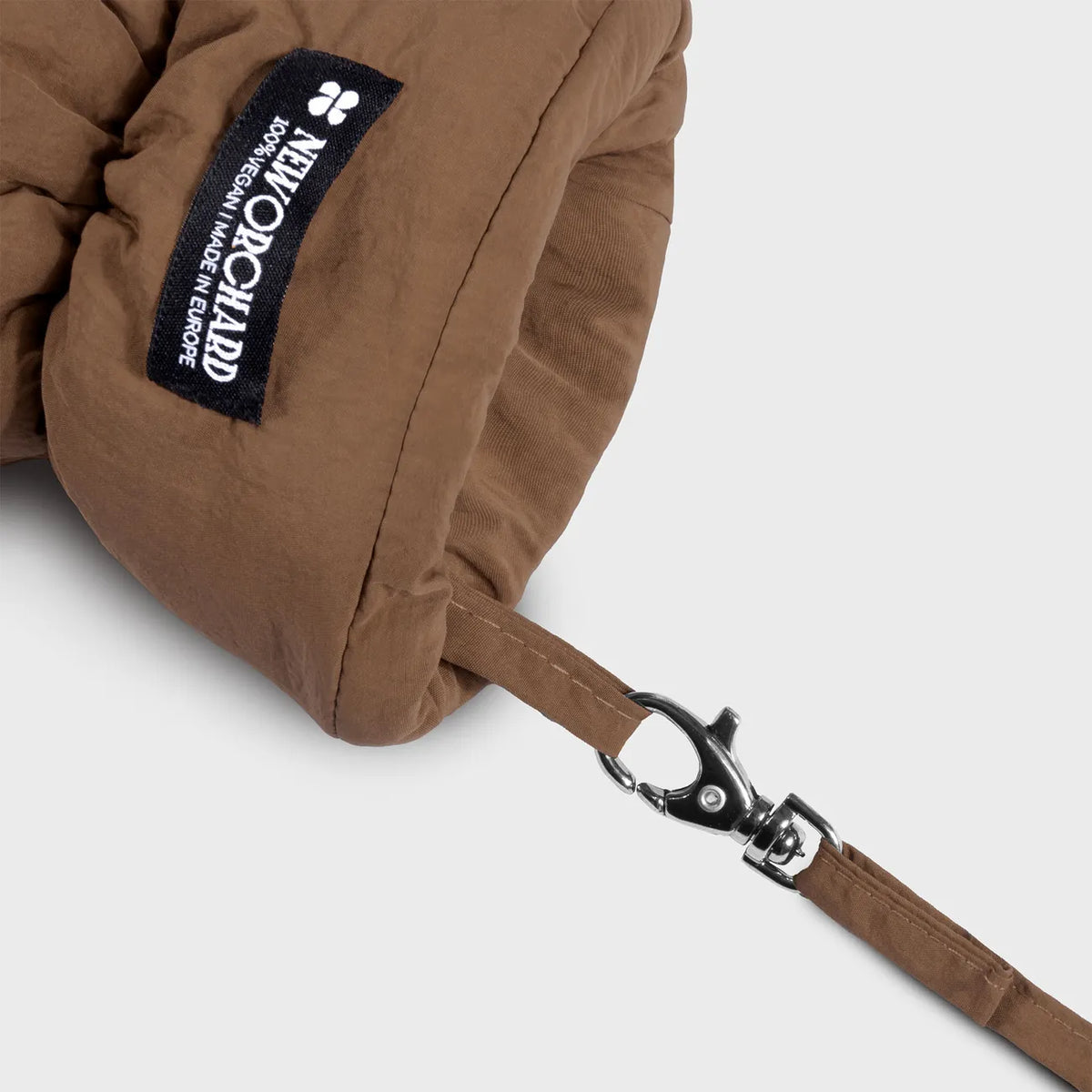 Brown vegan winter glove with recycled materials, adjustable wrist strap, and black logo patch. - The New Orchard - ⁠Warm Brown