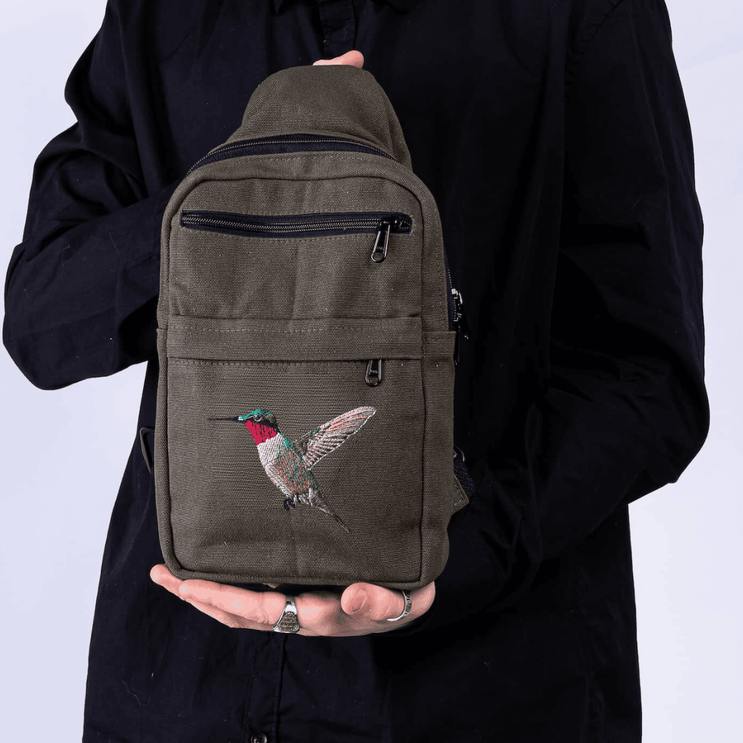 Umoja hummingbird embroidered canvas sling bag in green #color_green