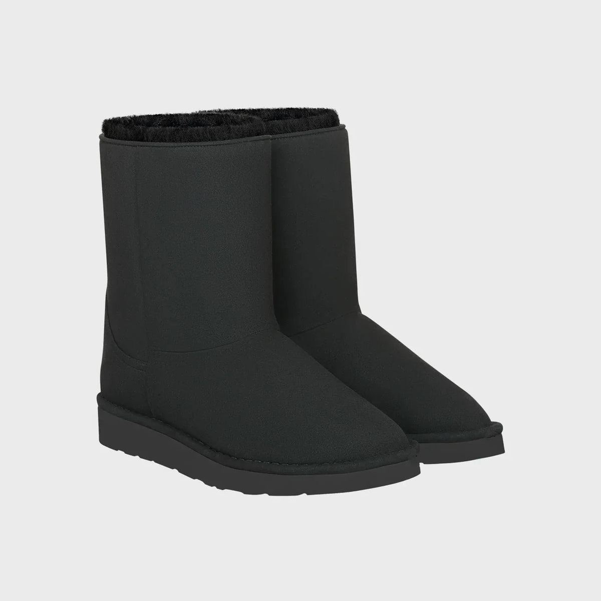 Pair of vegan black boots on a light gray background