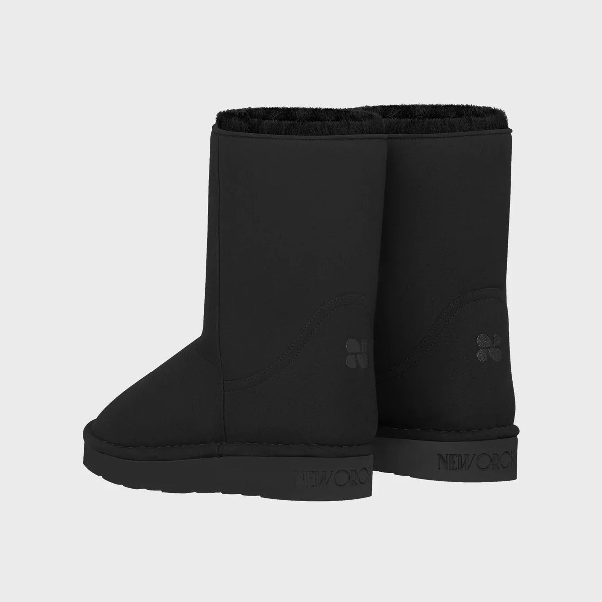 Black vegan boots with a brand logo on a light gray background