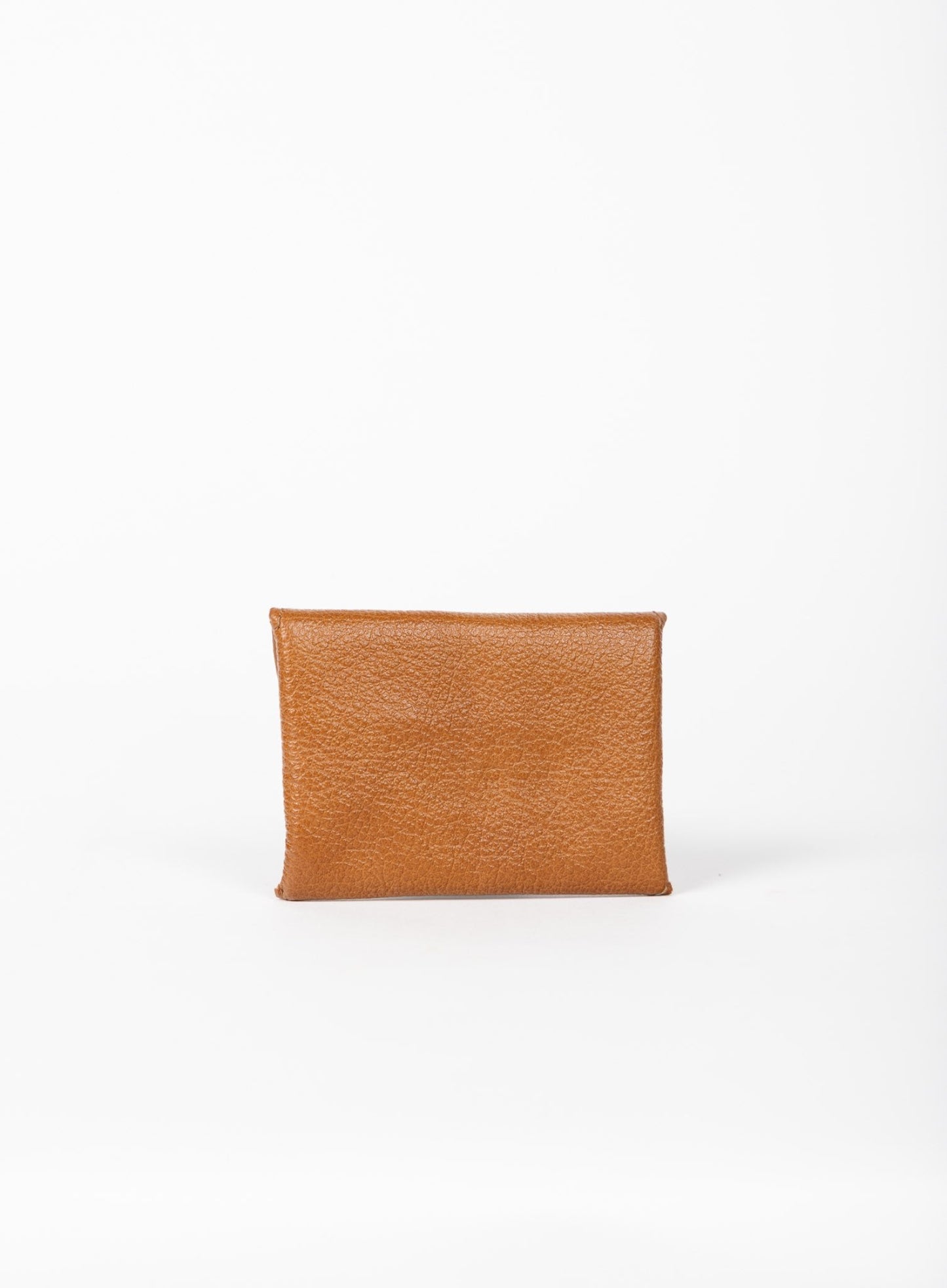 Cognac leather coin pouch on a white background