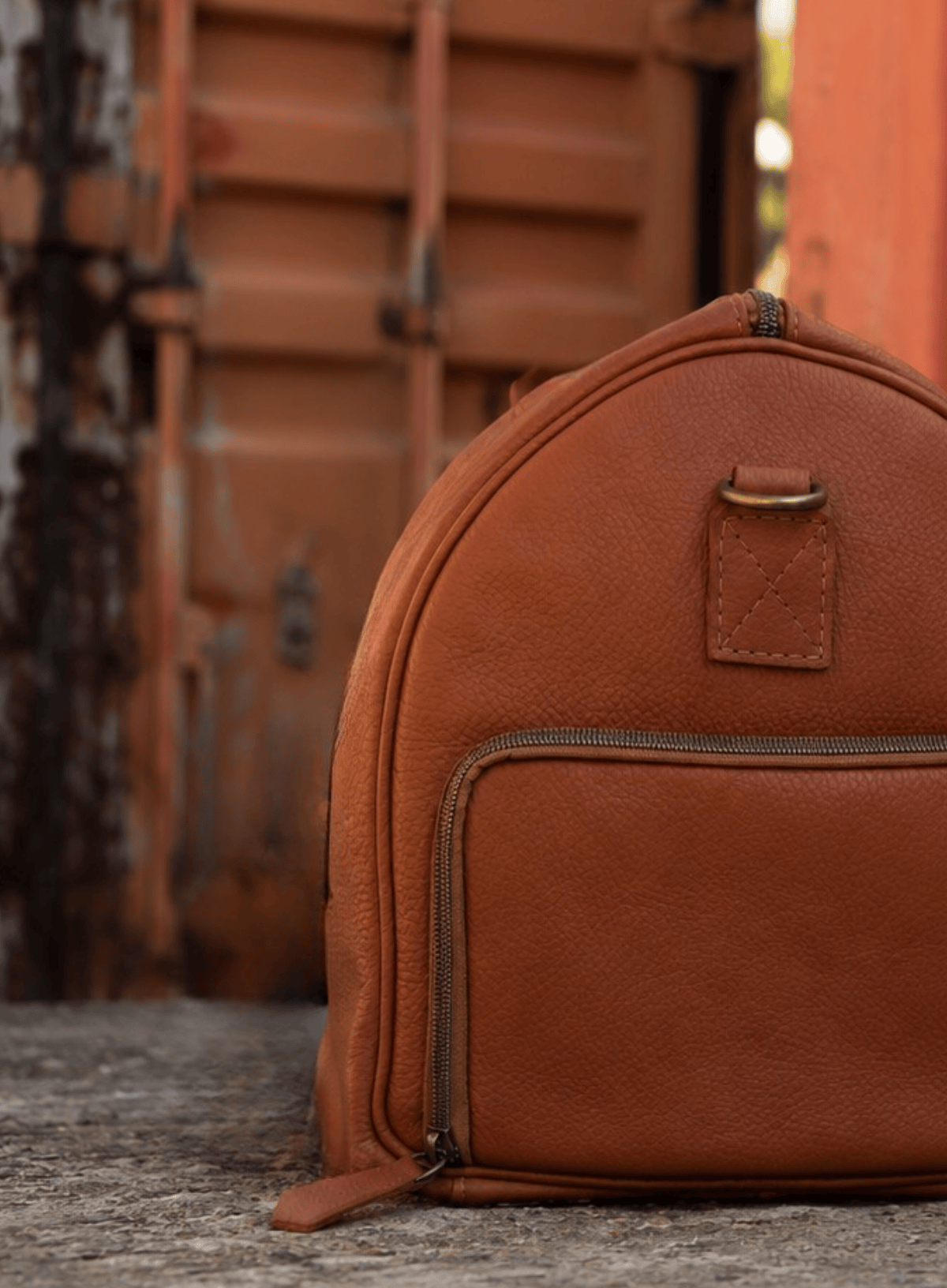 Brown leather backpack with a blurred background