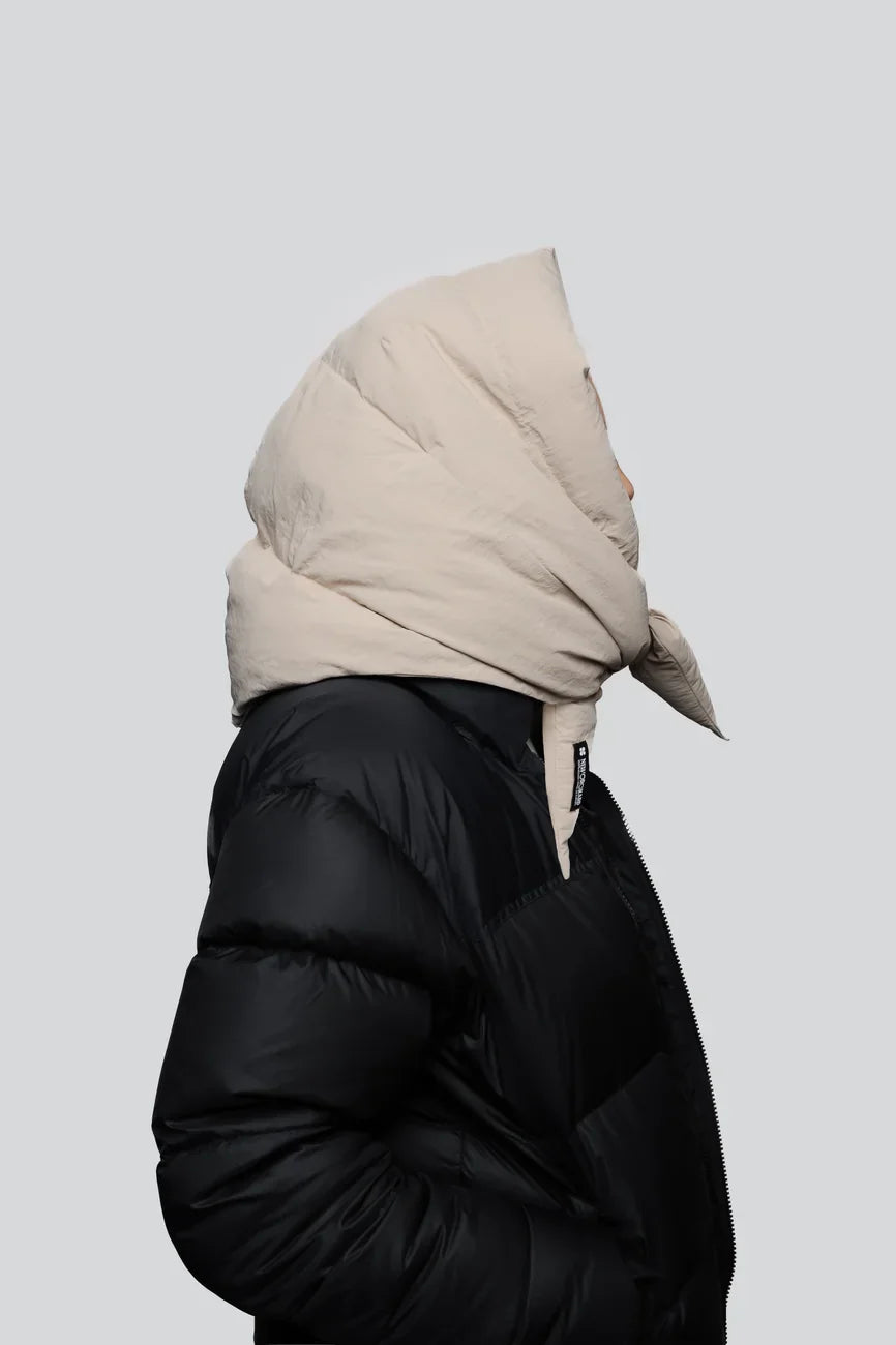 Light beige vegan winter capuche made from recycled materials, styled with black puffer jacket. - The New Orchard - Light Beige