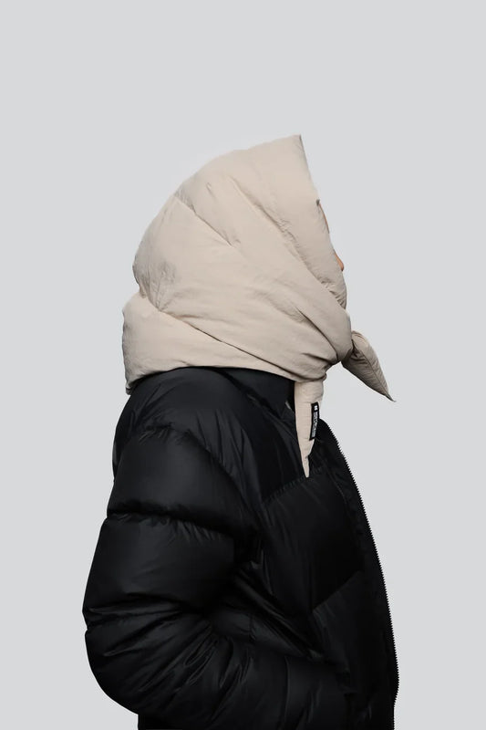 Light beige vegan winter capuche made from recycled materials, styled with black puffer jacket. - The New Orchard - Light Beige