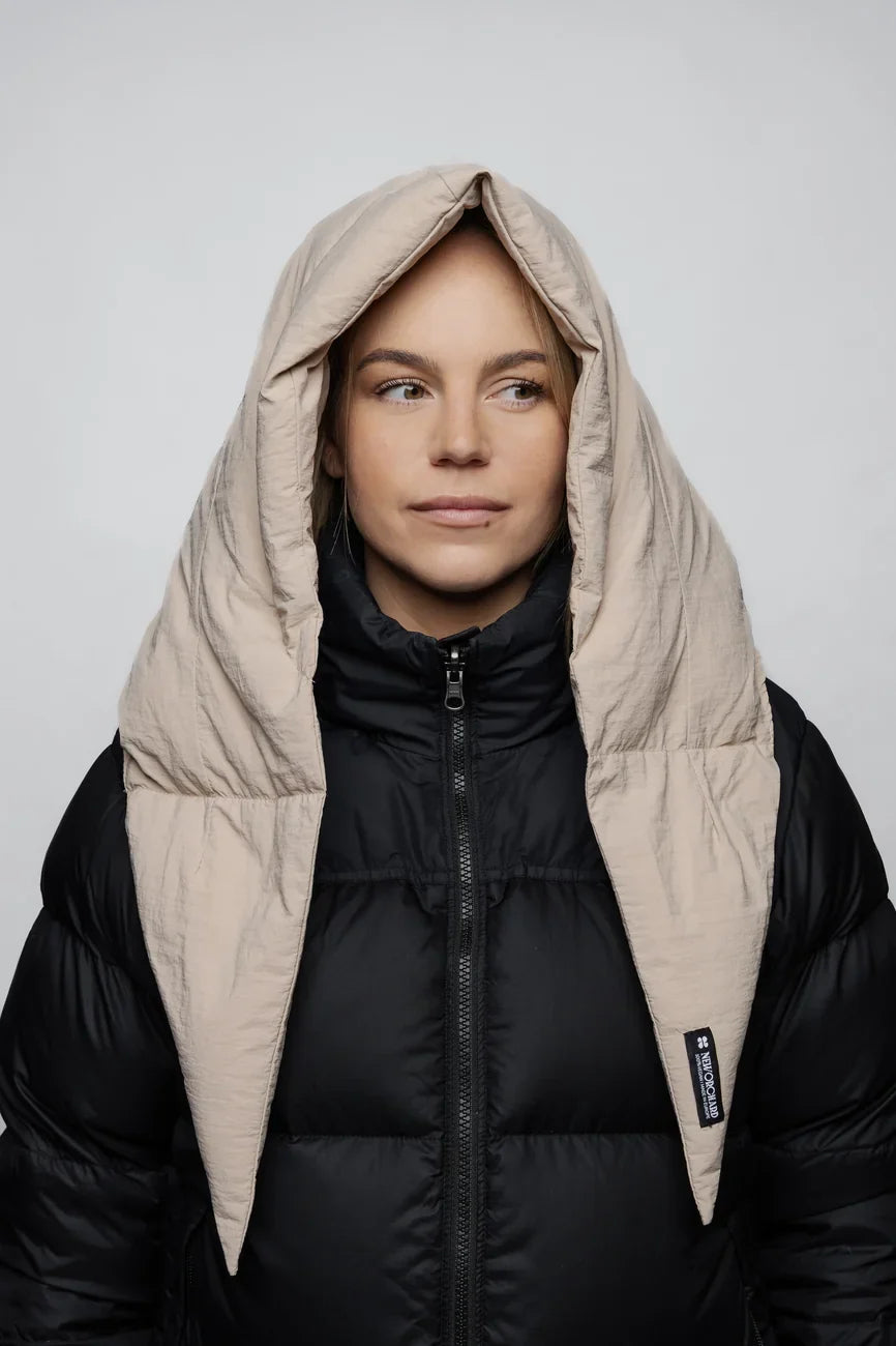 Light beige vegan puffer hood made from recycled materials, worn over black jacket. - The New Orchard - Light Beige