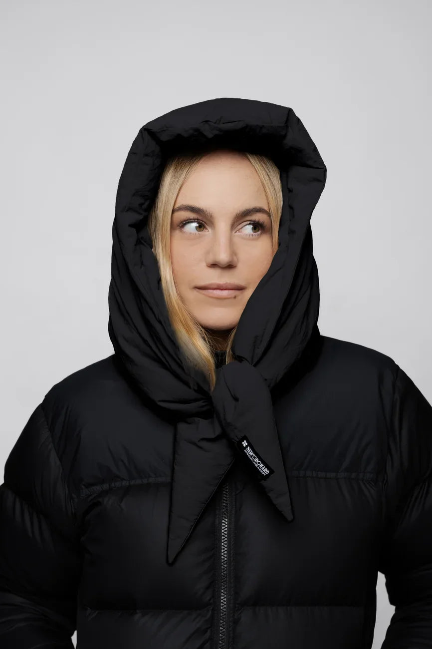 Black vegan puffer jacket with hood made from recycled materials, styled with hood up. - The New Orchard - Charcoal Black
